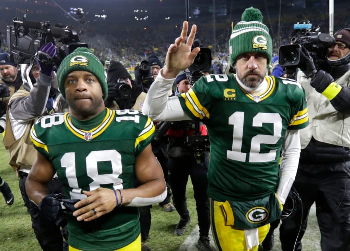 WR Randall Cobb (18) and QB Aaron Rodgers (12) leave Lambeau Field after the Packers' 2022 regular season finale